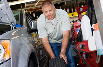 Mechanic working on another car