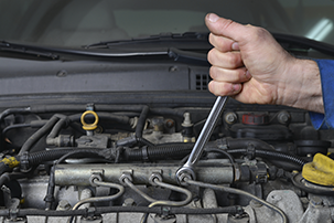 Close up of mechanic working on car
