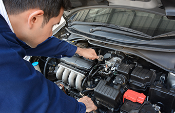Mechanic working on another car